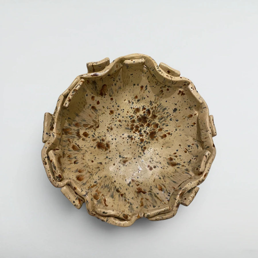 Hand-pinched ruffle-rim stoneware bowl with amber and blue freckled glaze bloomed in the kiln